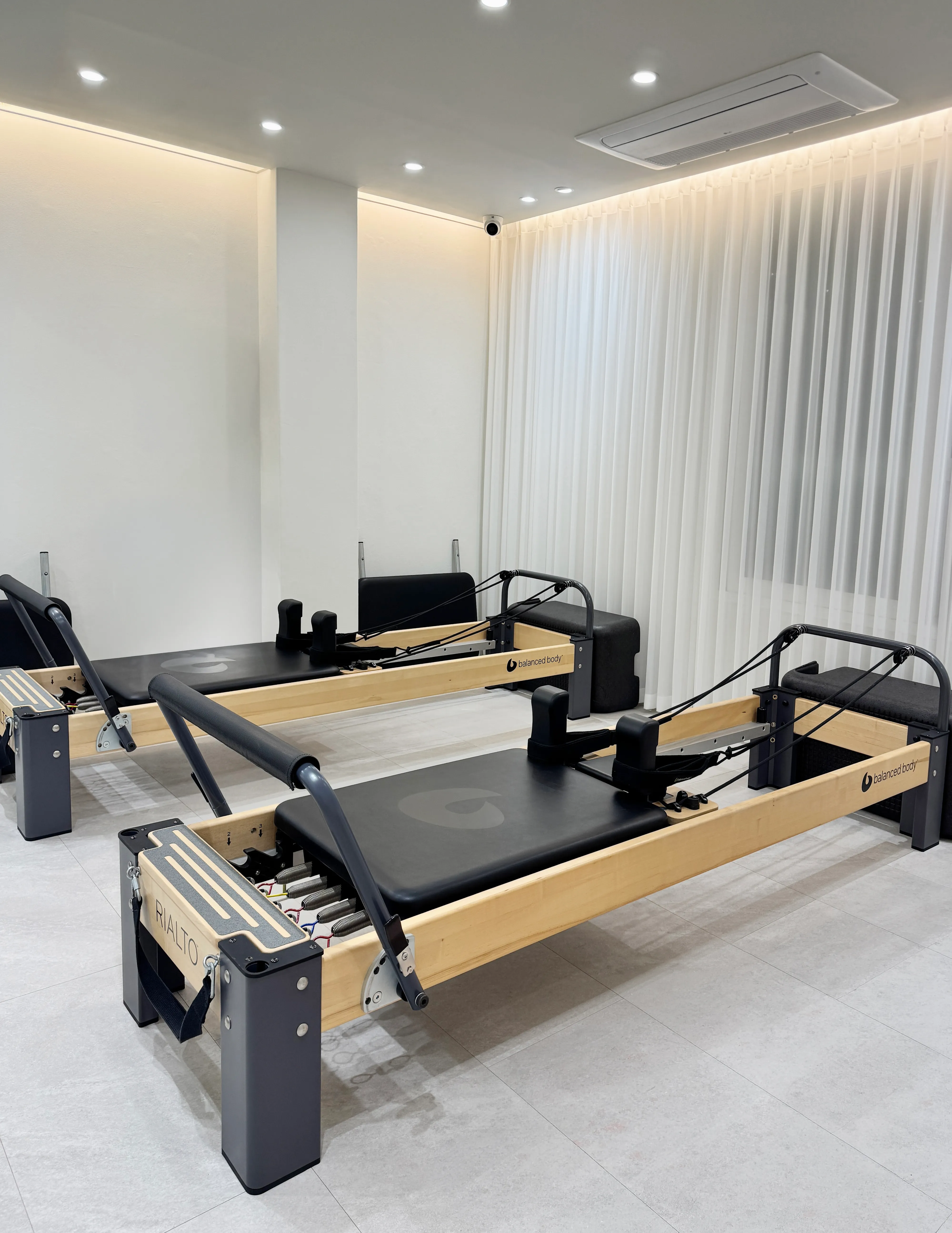 bright and clean pilates studio interior with reformers